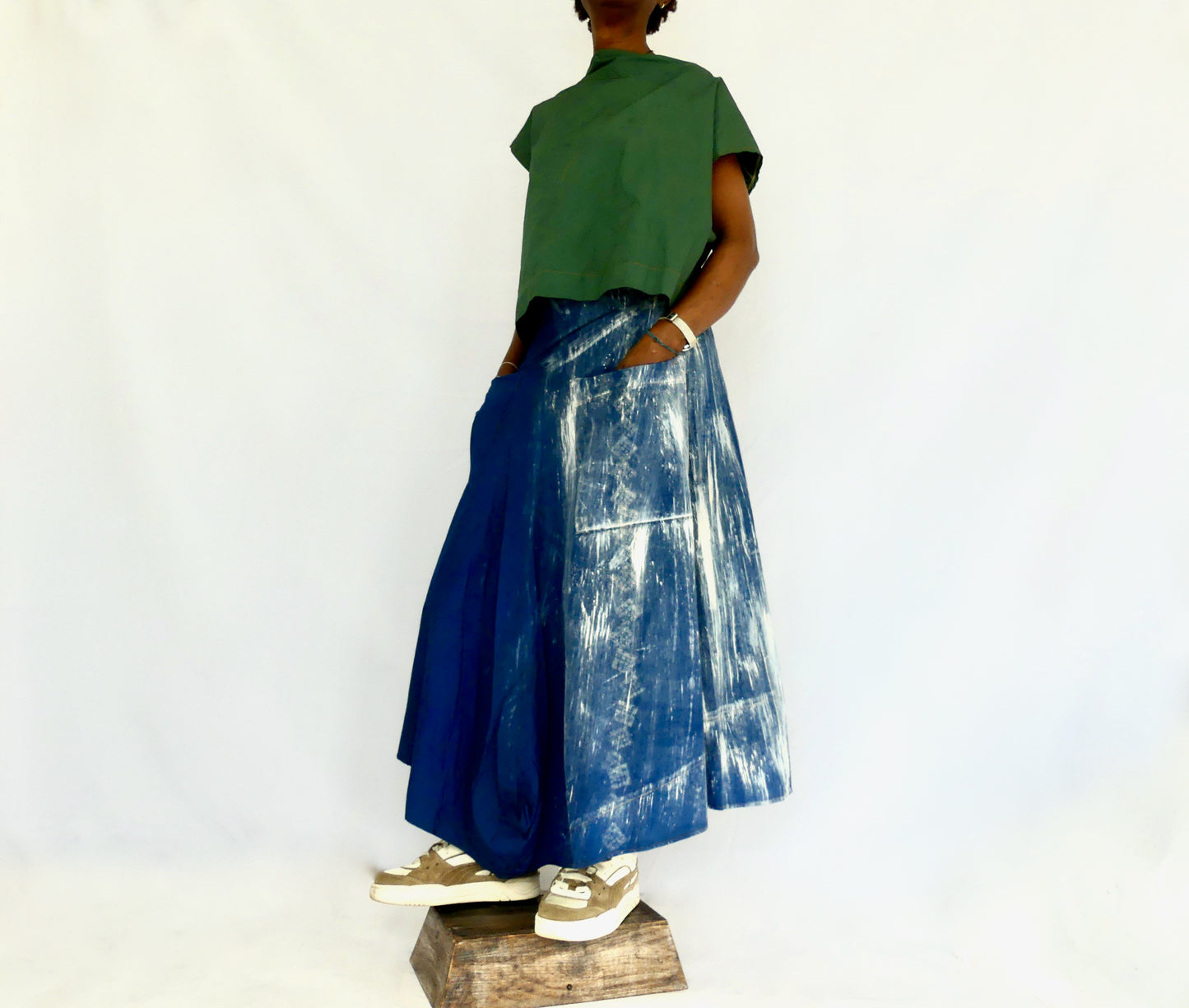 Iro Asymmetrical hand dyed cotton poplin skirt. Made from deadstock fabric, this skirt has a waist yoke, two waist straps and two deep front pockets and finished with a side zipper