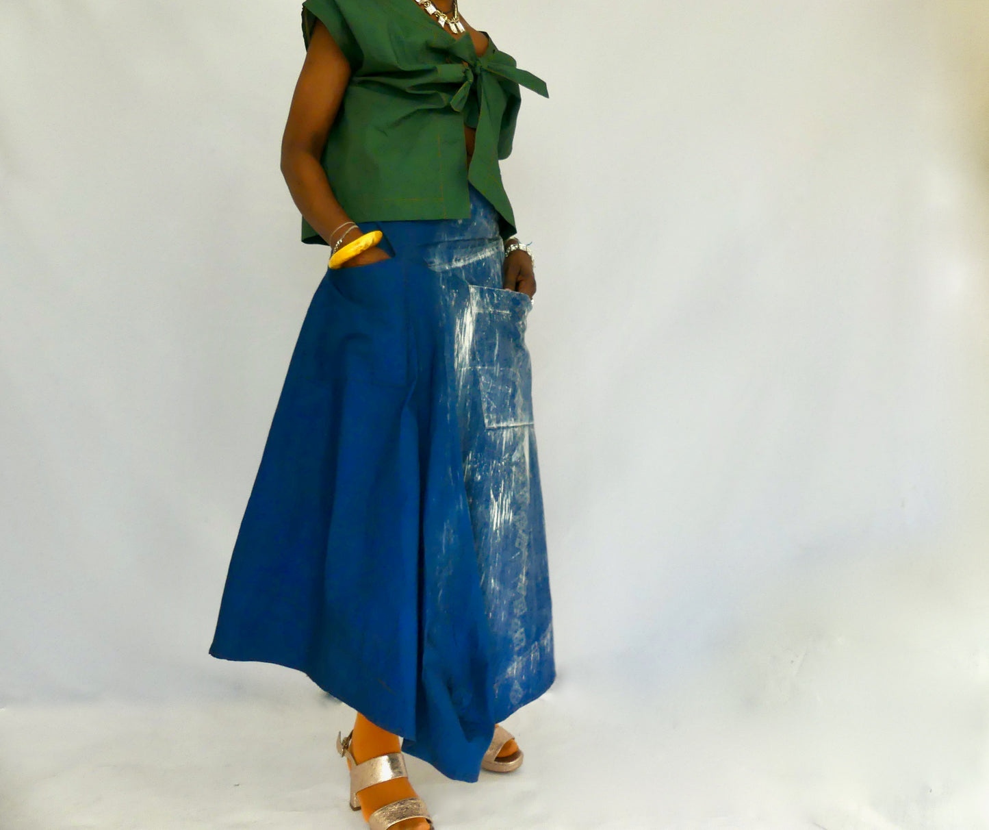 Iro Asymmetrical hand dyed cotton poplin skirt. Made from deadstock fabric, this skirt has a waist yoke, two waist straps and two deep front pockets and finished with a side zipper